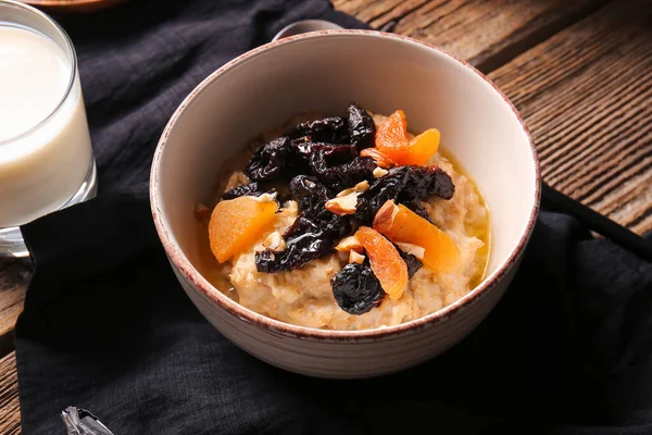 Bowl Sweet Oatmeal Prunes Dried Apricots Almond Nuts Wooden Table — Stock Photo, Image