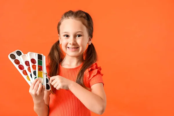 Cute Little Girl Pędzlem Farbami Akwarelowymi Czerwonym Tle — Zdjęcie stockowe