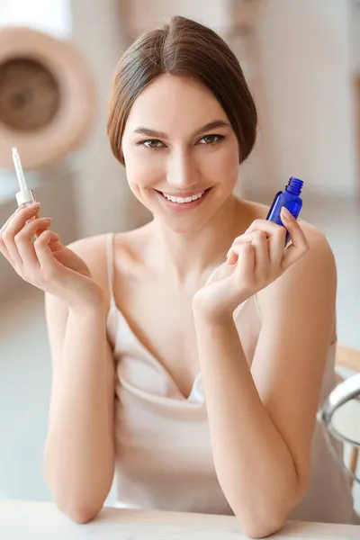 Young Smiling Woman Bottle Essential Oil Sitting Table Room — Stock Photo, Image