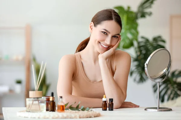 Beautiful Smiling Woman Sitting Table Bottles Essential Oil Room — Stock Photo, Image