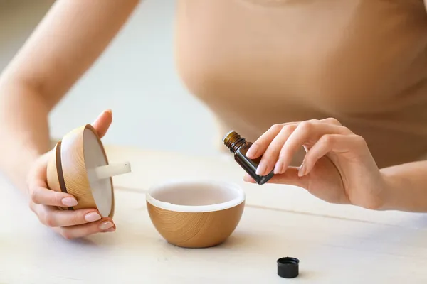 Woman Adding Essential Oil Diffuser Table Closeup — Stock Photo, Image