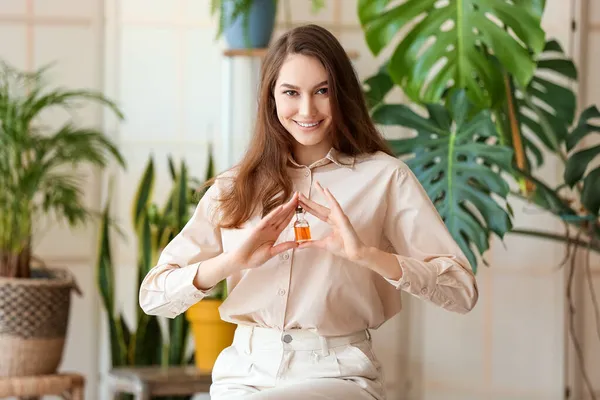 Fashionable Smiling Woman Holding Bottle Essential Oil Room — Stock Photo, Image