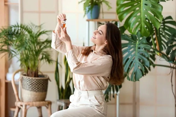 Fashionable Smiling Woman Opening Bottle Essential Oil Room — Stock Photo, Image