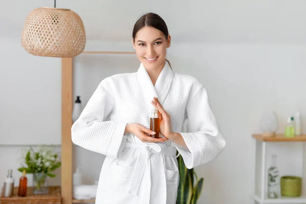 Smiling Young Woman Holding Bottle Natural Essential Oil Bathroom — Stock Photo, Image