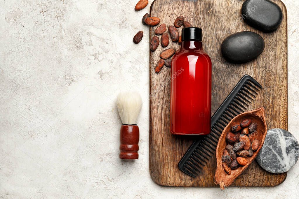 Composition with bath supplies and cocoa beans on light background