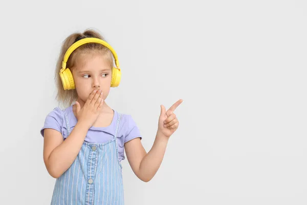 Funny Little Girl Listening Music Pointing Something Light Background — Stock Photo, Image
