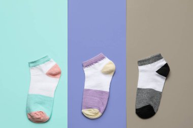 Different socks on color background clipart