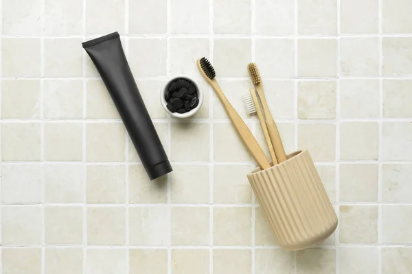 Black Toothpaste Activated Carbon Pills Brushes Bath Tile Background — Stock Photo, Image