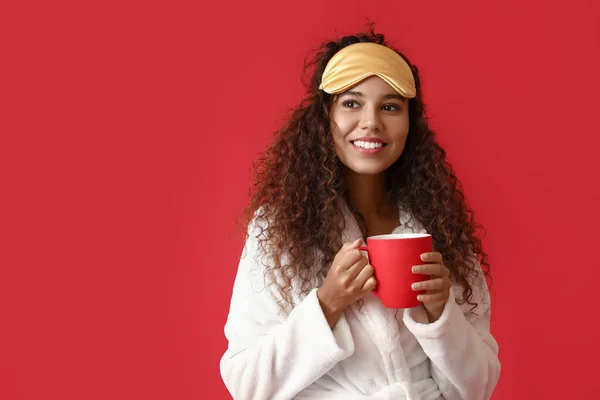 Young African American Woman Sleeping Mask Cup Coffee Red Background — Stock Photo, Image