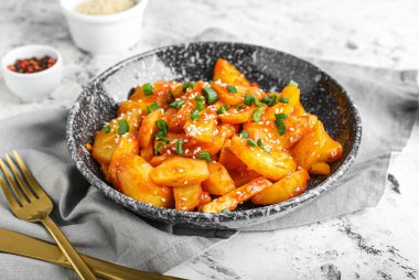 Hafif arka planda bal biberli patates tabağı.