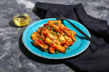 Arkaplanda bal biberli patates tabağı.