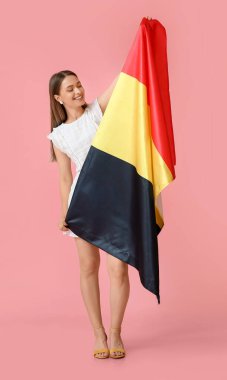 Young woman with flag of Belgium on color background clipart