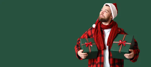 Happy Man Santa Hat Holding Christmas Gift Boxes Green Background — Stock Photo, Image