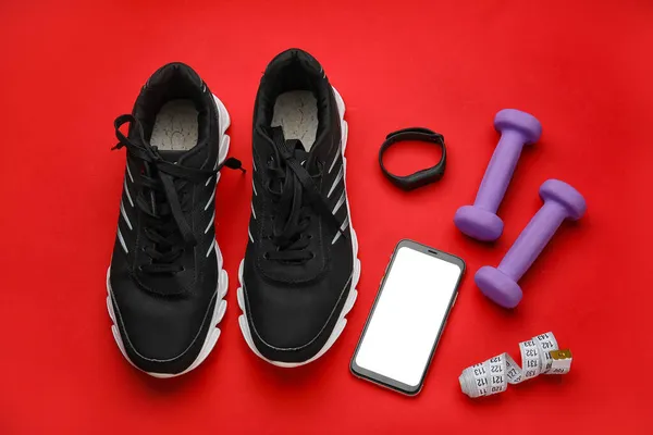 Dumbbells Shoes Gadgets Red Background — Stock Photo, Image