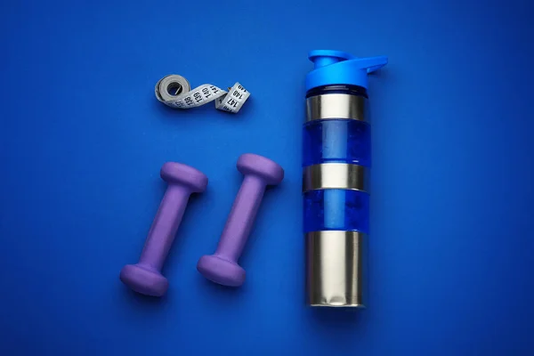 Dumbbells Bottle Water Measuring Tape Blue Background — Stock Photo, Image