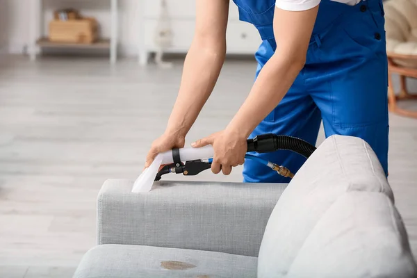 Male Worker Removing Dirt Grey Sofa Vacuum Cleaner Room — Stock Photo, Image