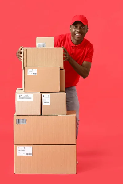 African American Delivery Man Many Parcels Color Background — Stock Photo, Image