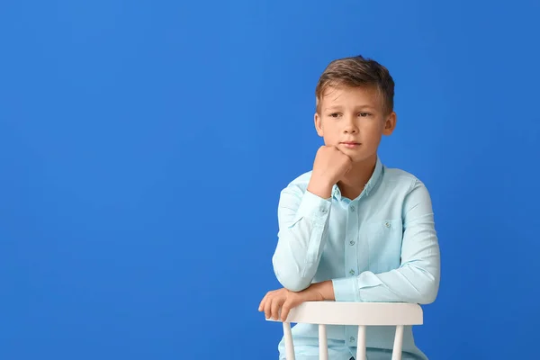 Thoughtful Little Boy Sitting Chair Blue Background — Stock Photo, Image