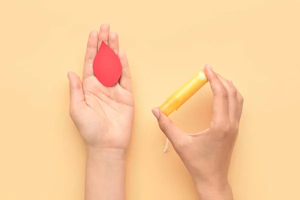 Female Hands Menstrual Tampon Paper Blood Drop Yellow Background — Stock Photo, Image