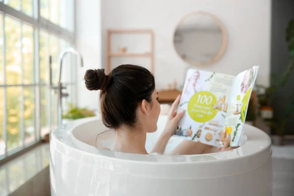 Pretty Young Woman Reading Magazine While Taking Bath Home — Stock Photo, Image