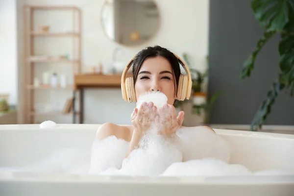 Mujer Bastante Joven Auriculares Soplando Espuma Bañera — Foto de Stock