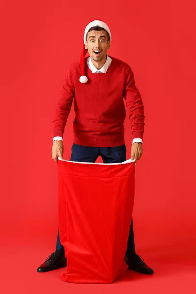 Surprised Young Man Santa Bag Red Background — Stock Photo, Image