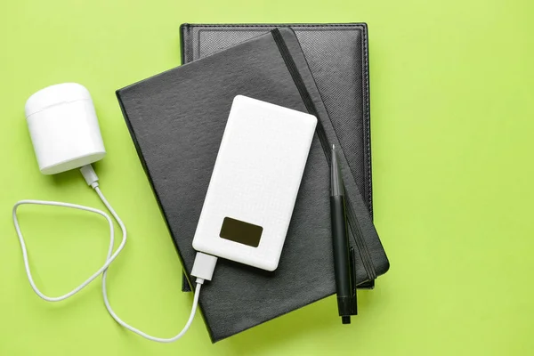 Modern Power Bank Case Earphones Notebooks Green Background — Stock Photo, Image