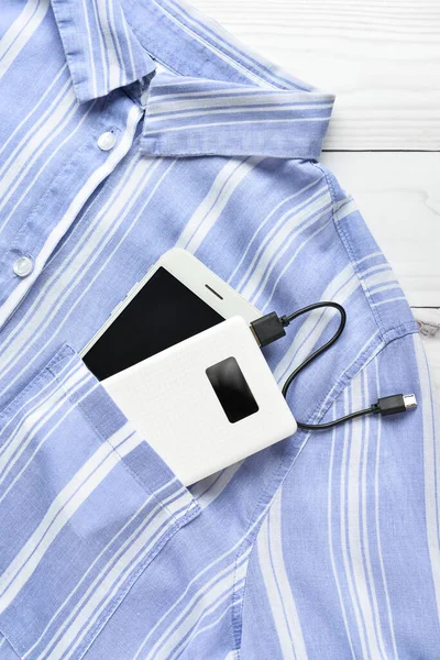 Modern Power Bank Mobile Phone Shirt White Wooden Background — Stock Photo, Image