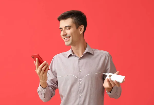 Young Man Phone Power Bank Color Background — Stock Photo, Image