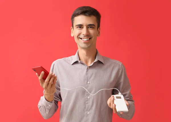 Young Man Phone Power Bank Color Background — Stock Photo, Image