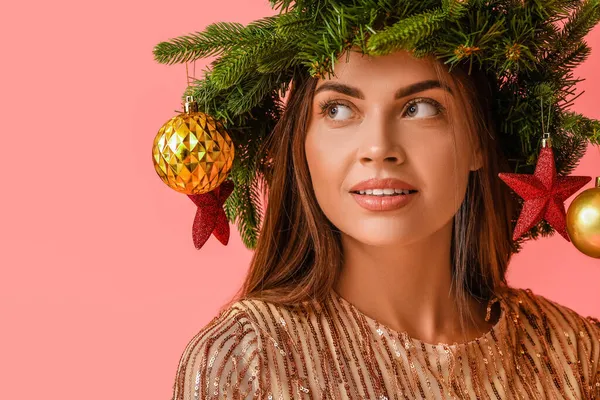 Pembe Arka Planda Noel Dekoru Olan Çelenkli Güzel Bir Kadın — Stok fotoğraf