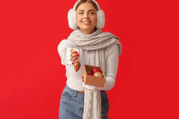 Beautiful Young Woman Warm Earmuffs Christmas Balls Red Background — Stock Photo, Image