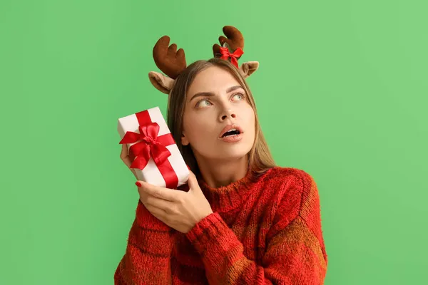 Shocked Young Woman Deer Horns Christmas Gift Green Background — Stock Photo, Image