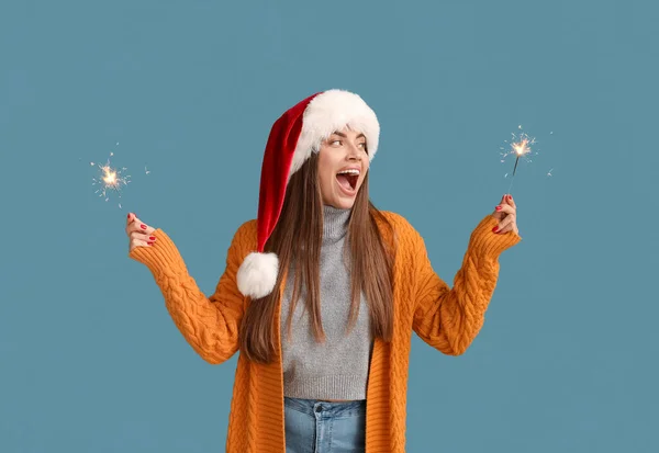 Happy Young Woman Santa Hat Christmas Sparklers Blue Background — Stock Photo, Image