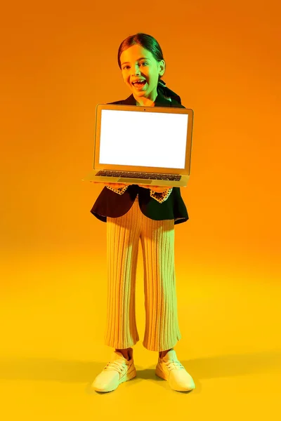 黄色の背景にノートパソコンを持つ少女 ブラック フライデー販売 — ストック写真