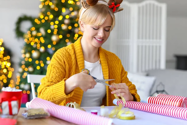 Beautiful Young Woman Packing Christmas Gift Home — Stock Photo, Image