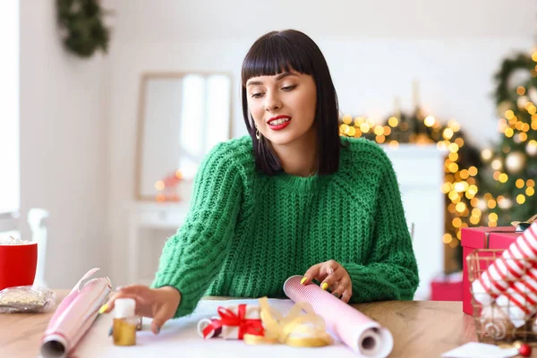 Beautiful Young Woman Wrapping Christmas Gift Home — Stock Photo, Image