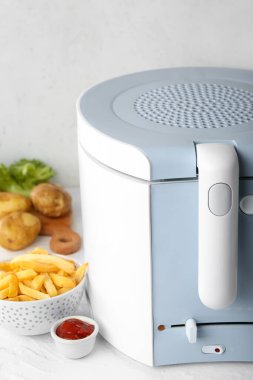 Sofrada lezzetli fast food kaseleri olan bir fritöz.