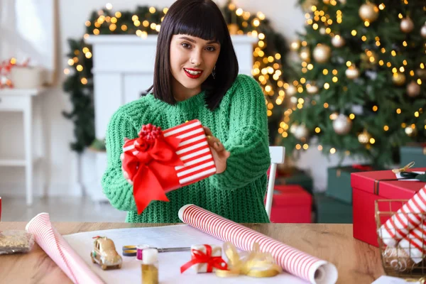 Beautiful Young Woman Wrapping Christmas Gift Home — Stock Photo, Image