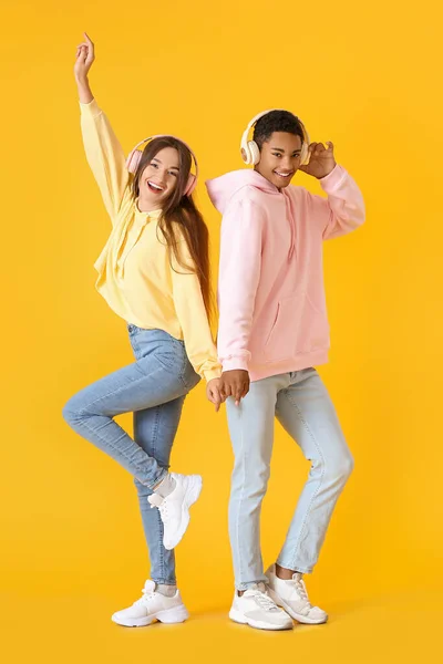 Stylish Young Couple Hoodies Listening Music Yellow Background — Stock Photo, Image