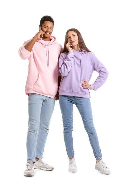 Stylish Young Couple Hoodies Talking Mobile Phones White Background — Stock Photo, Image