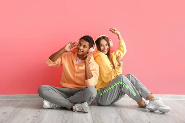 Elegante Pareja Joven Sudaderas Con Capucha Con Auriculares Cerca Pared — Foto de Stock