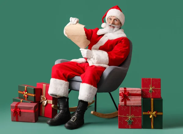 Santa Claus Reading Wish List Green Background — Stock Photo, Image