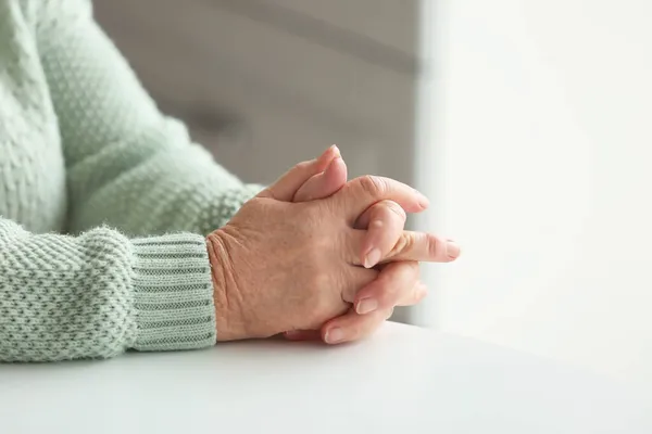 Руки Пожилой Женщины Сидят Столом — стоковое фото