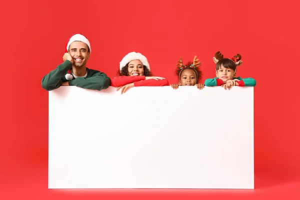 Kırmızı Arka Planda Boş Posteri Olan Noel Elbiseli Mutlu Aile — Stok fotoğraf