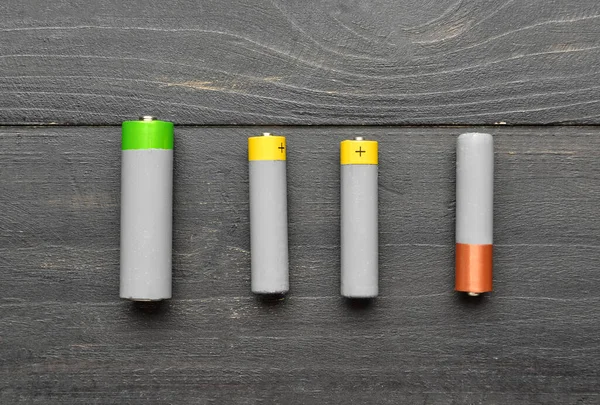 Alkaline Batteries Black Wooden Background — Stock Photo, Image