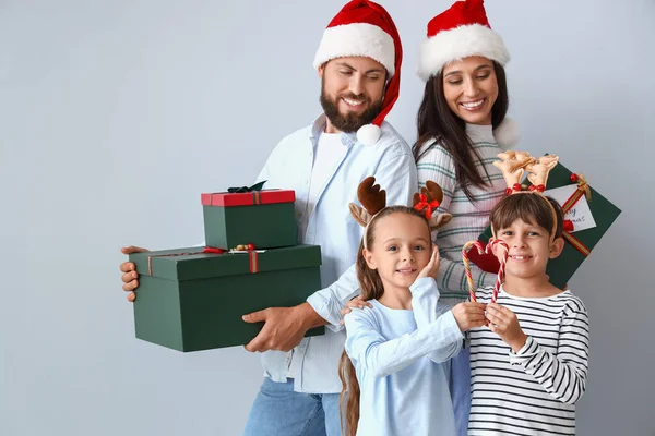 Happy Family Santa Hats Christmas Gifts Candy Canes Light Background — Stock Photo, Image