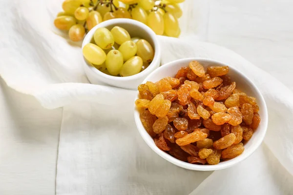Bowls Tasty Raisins Ripe Grapes Light Background Closeup — Stock Photo, Image