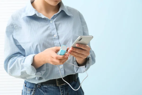 Young Woman Smartphone Power Bank Blue Wall Closeup — Stock Photo, Image