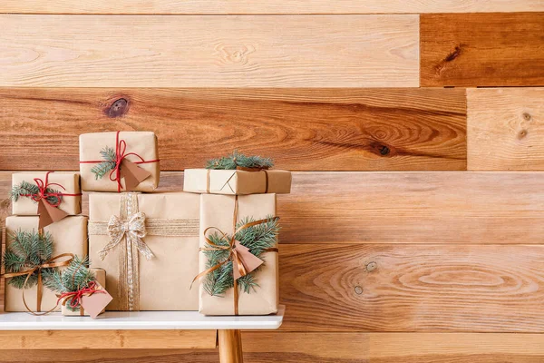 Table Christmas Gift Boxes Fir Branches Wooden Wall — Stock Photo, Image